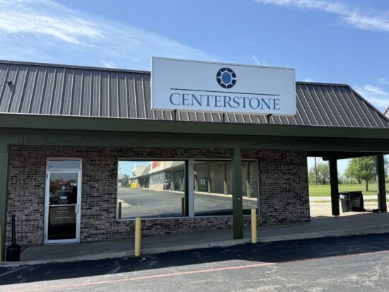 Centerstone sign above the entrance to a brick storefront.