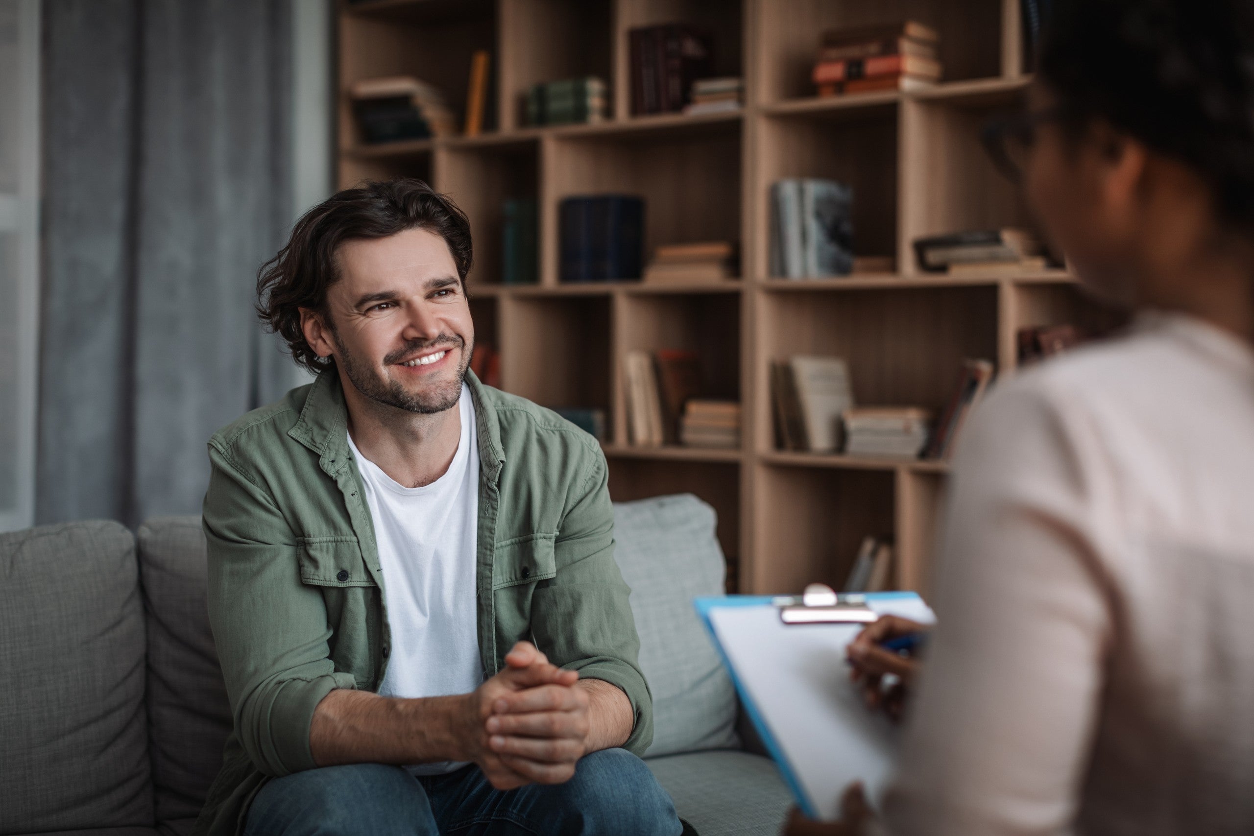 Man speaking with a clinician during a mental health screening