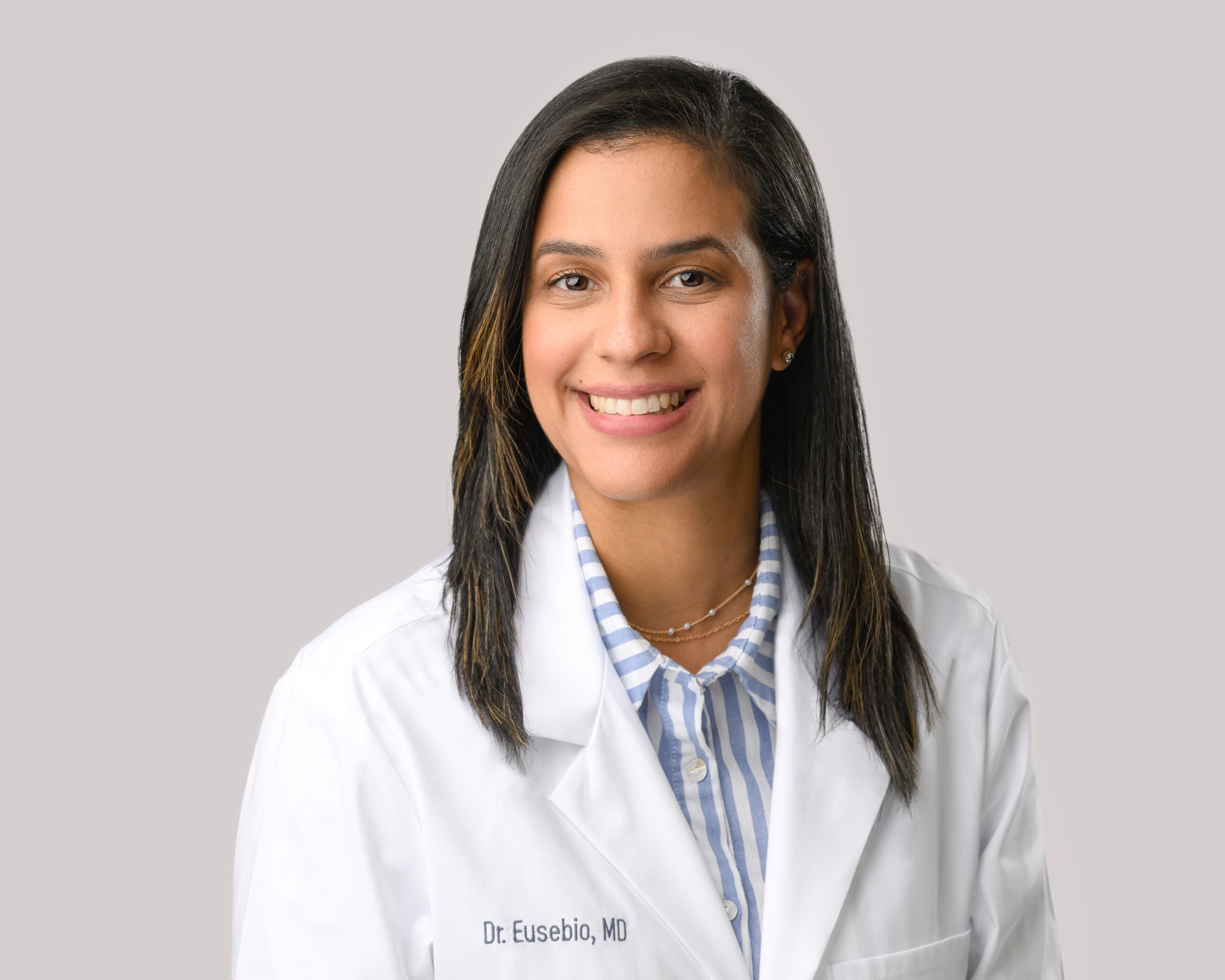 Portrait of Ana Eusebio, M.D. in a white lab coat