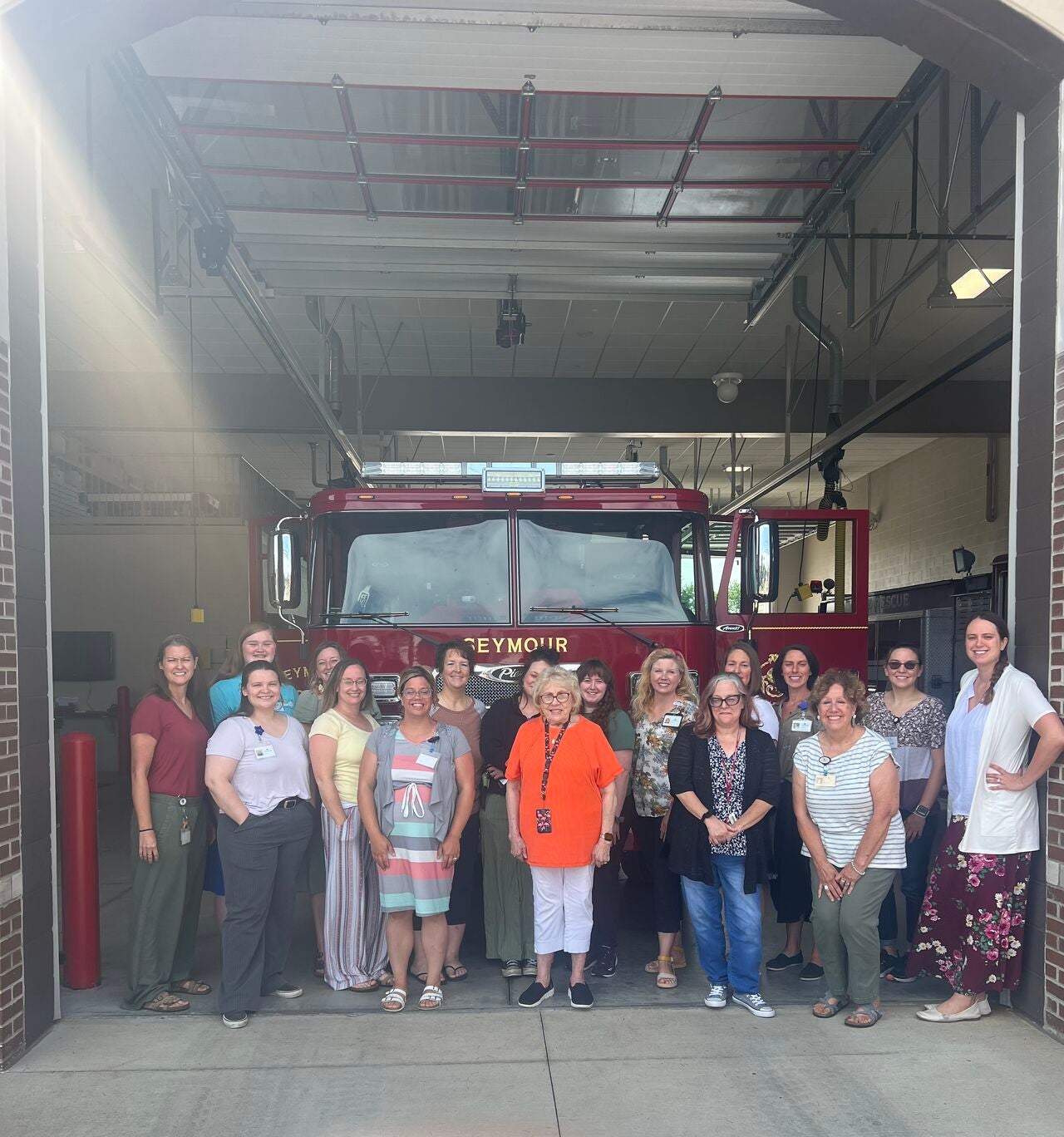 Seymour Office Fire Dept Meeting Centerstone staff gathered in front of a fire engine outside the local fire department.