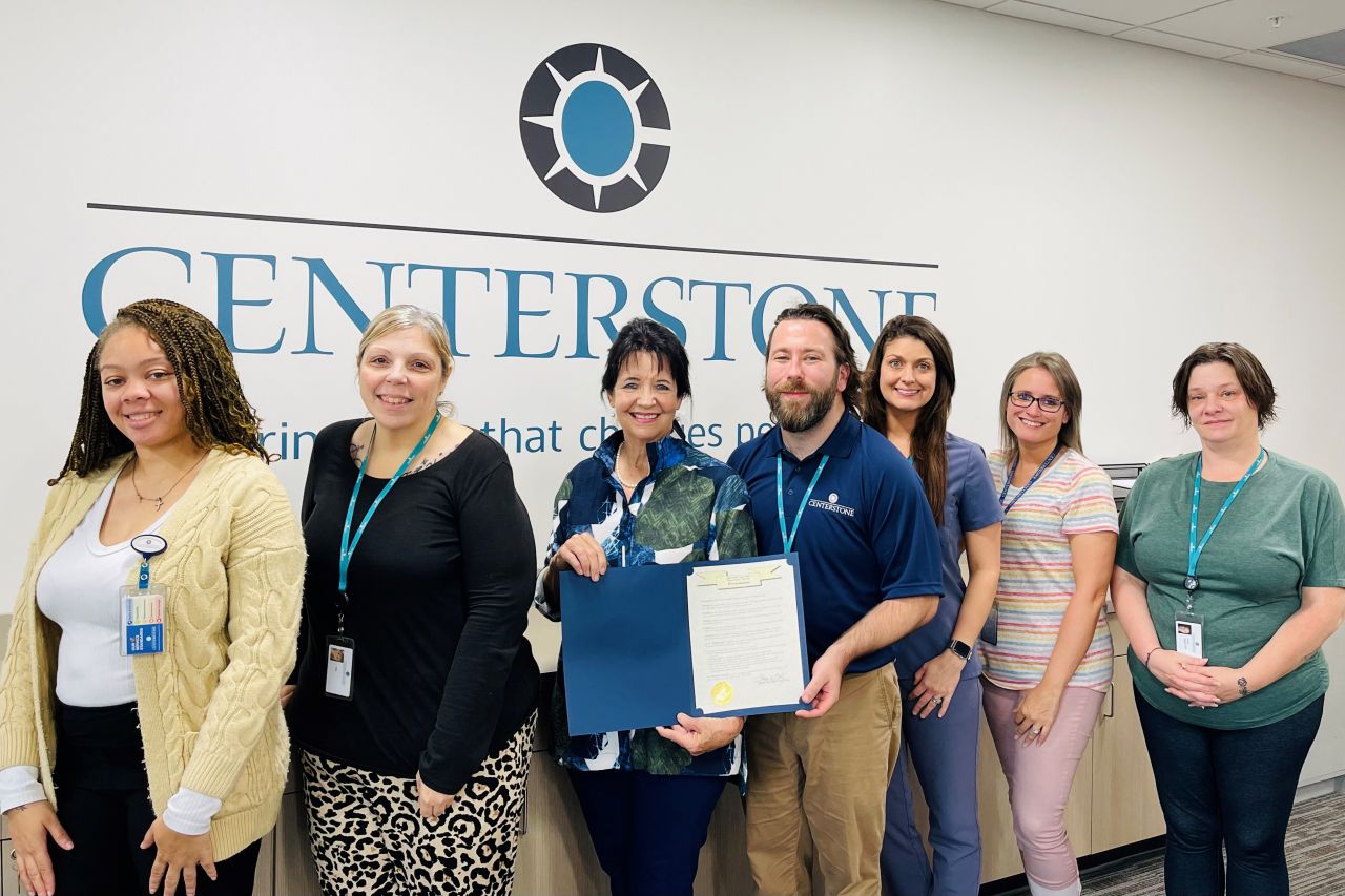 Staff with Proclamation Several Centerstone staff posing for a picture inside a clinic presenting a proclamation.