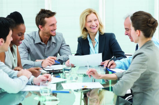 Smiling business people in a meeting at a table