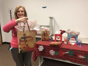 Sunrise Rotarian Jean Ozols is pictured handing out Christmas gifts